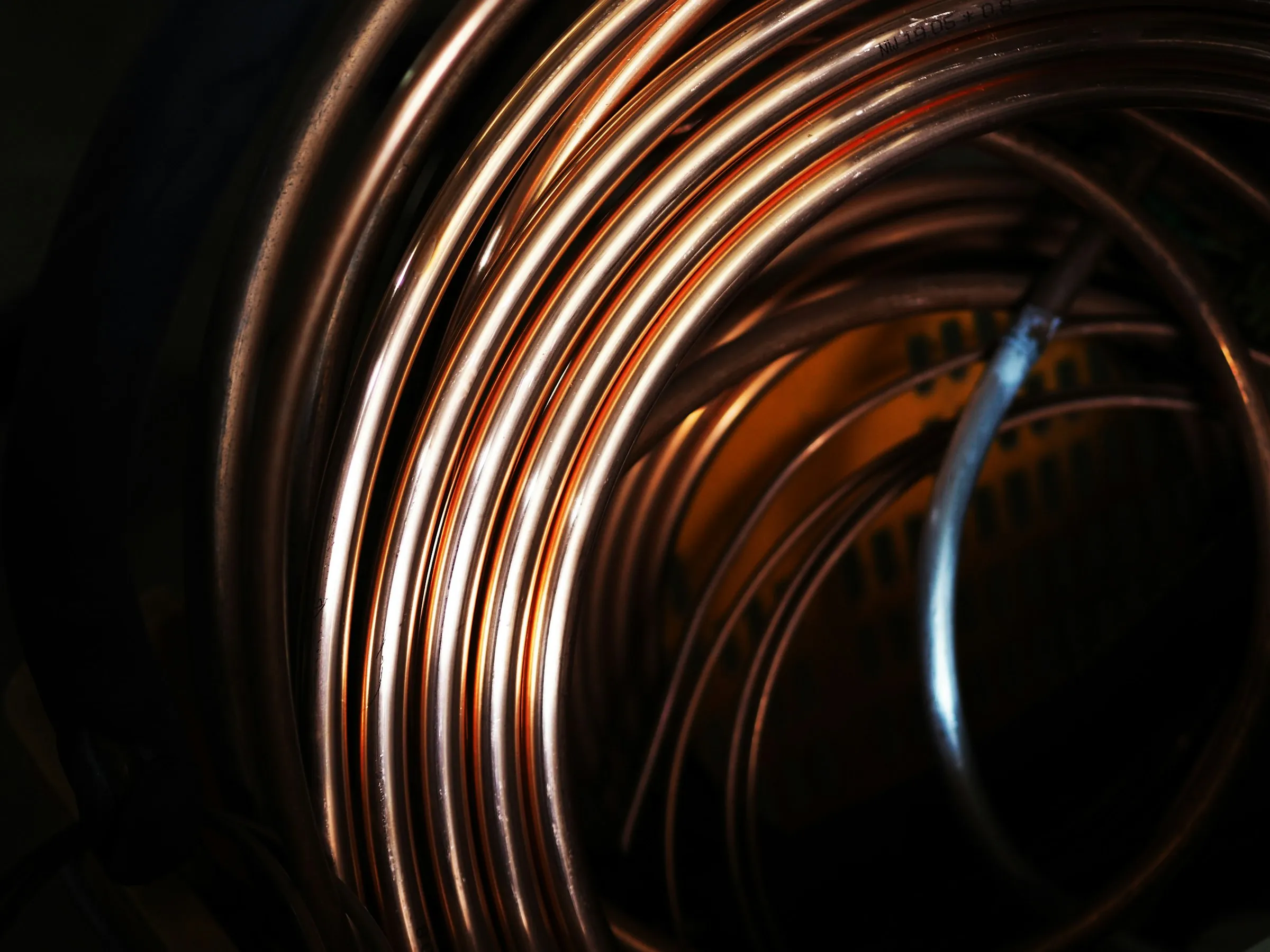 Coiled copper wire — the raw material behind magnetics and cable.