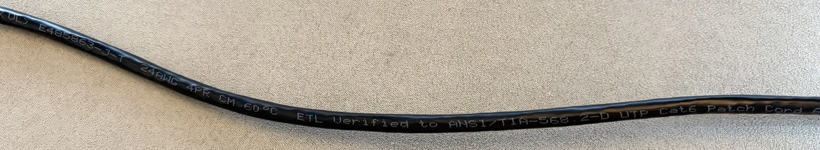 A genuine Cat6 jacket printed with a UL file, 24AWG 4PR CM, and ETL Verified to ANSI/TIA-568.2-D Cat6 Patch Cord.