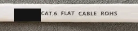 A flat cable jacket with the brand name redacted, printed CAT.6 FLAT CABLE ROHS.