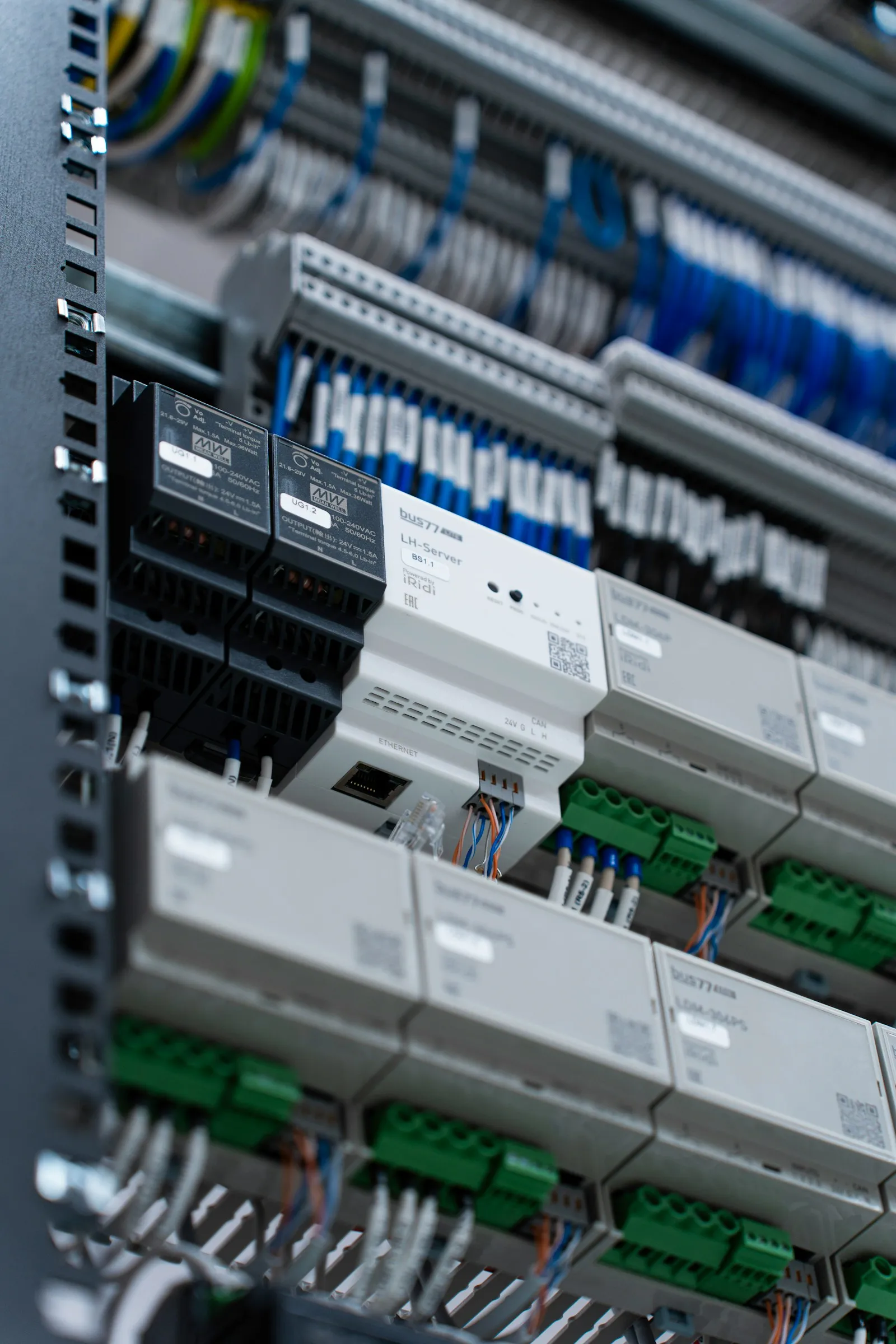 DIN-rail 24V power supplies and control modules mounted in an automation cabinet.
