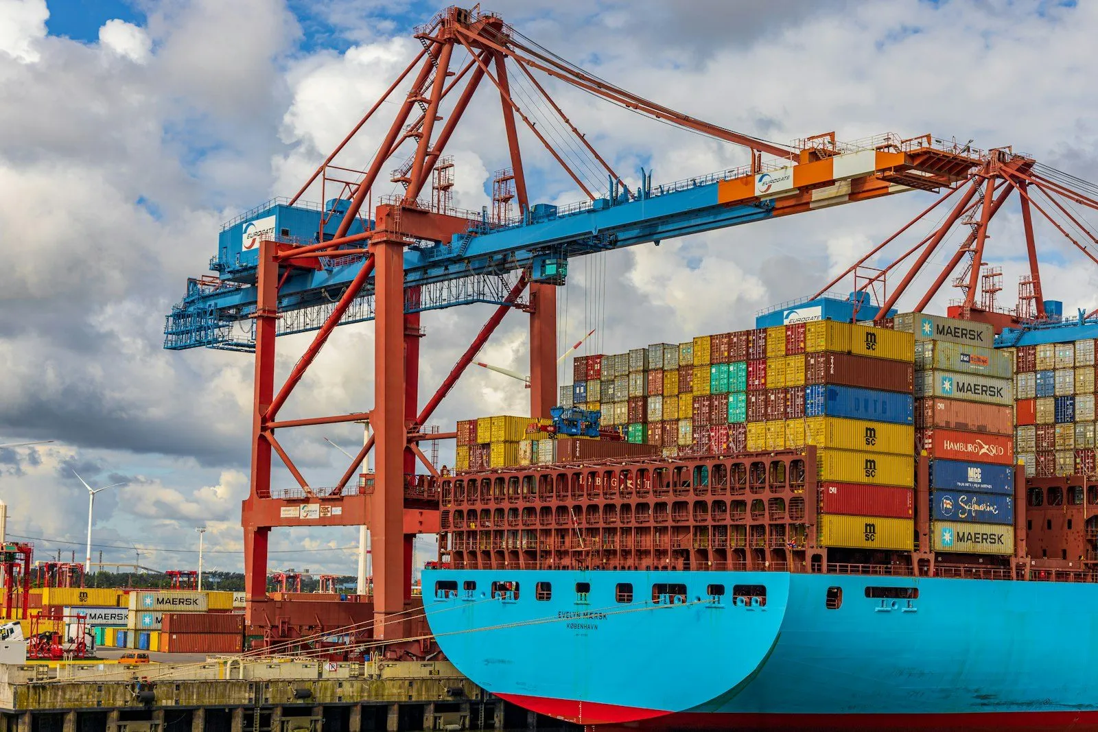 Stacked shipping containers at a port terminal, where duty accrues at entry.