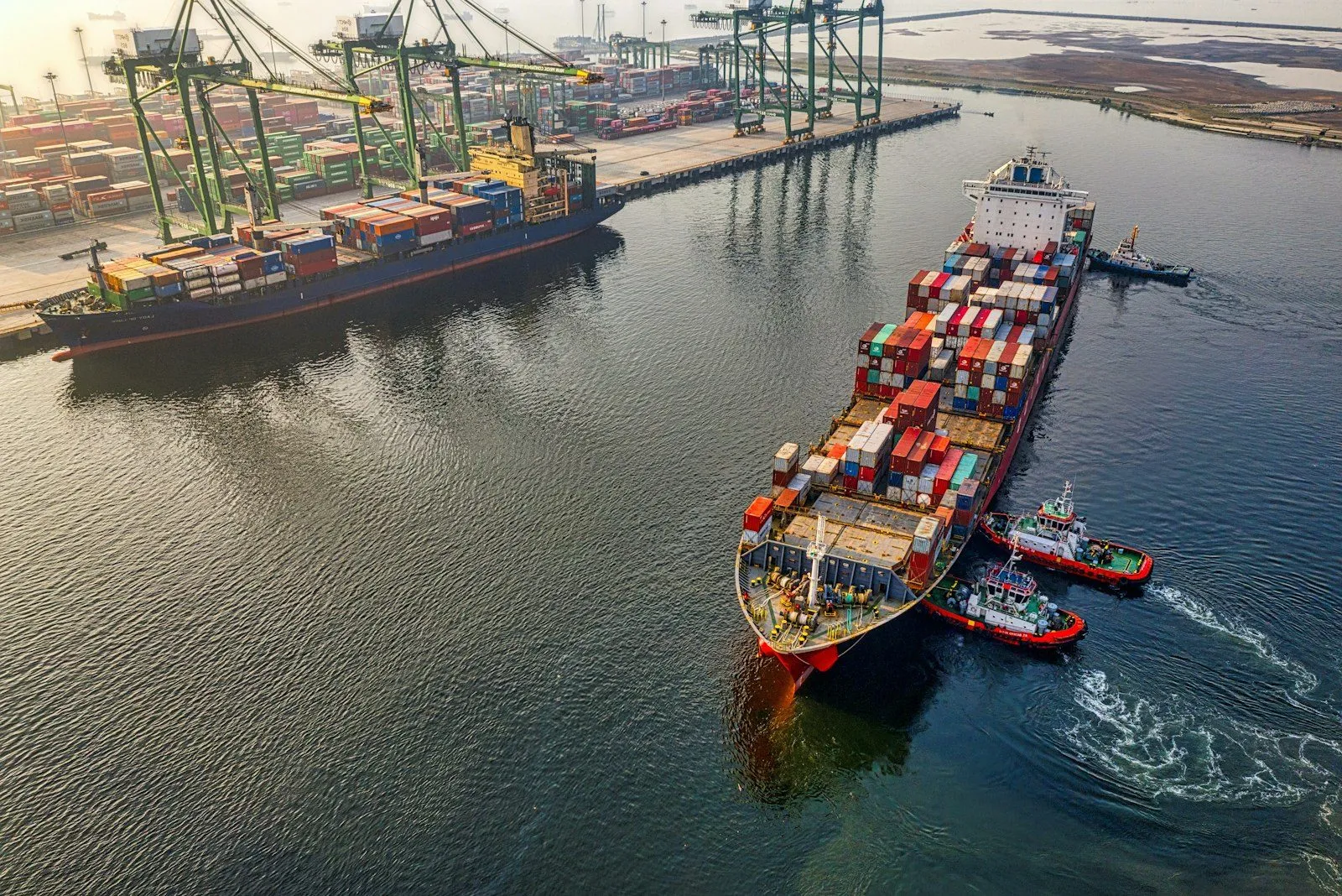 A cargo container ship at sea — the origin decision is an import decision.