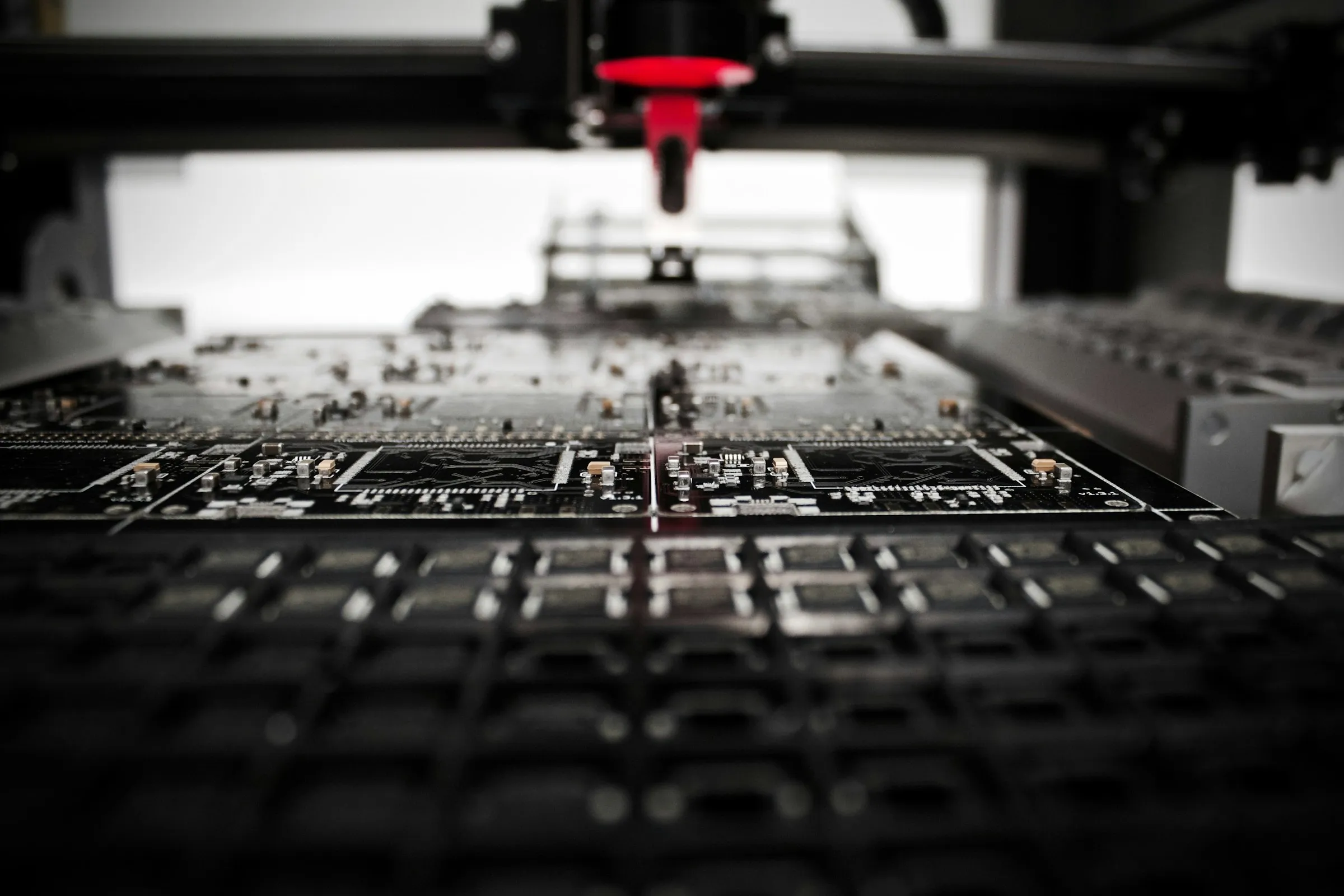 A surface-mount pick-and-place machine populating printed circuit boards on the line.