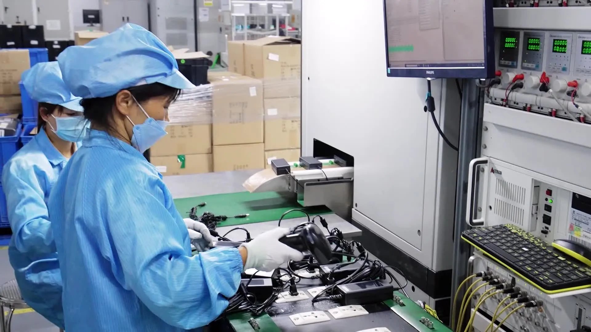 Technicians running electrical final-test on finished power adapters